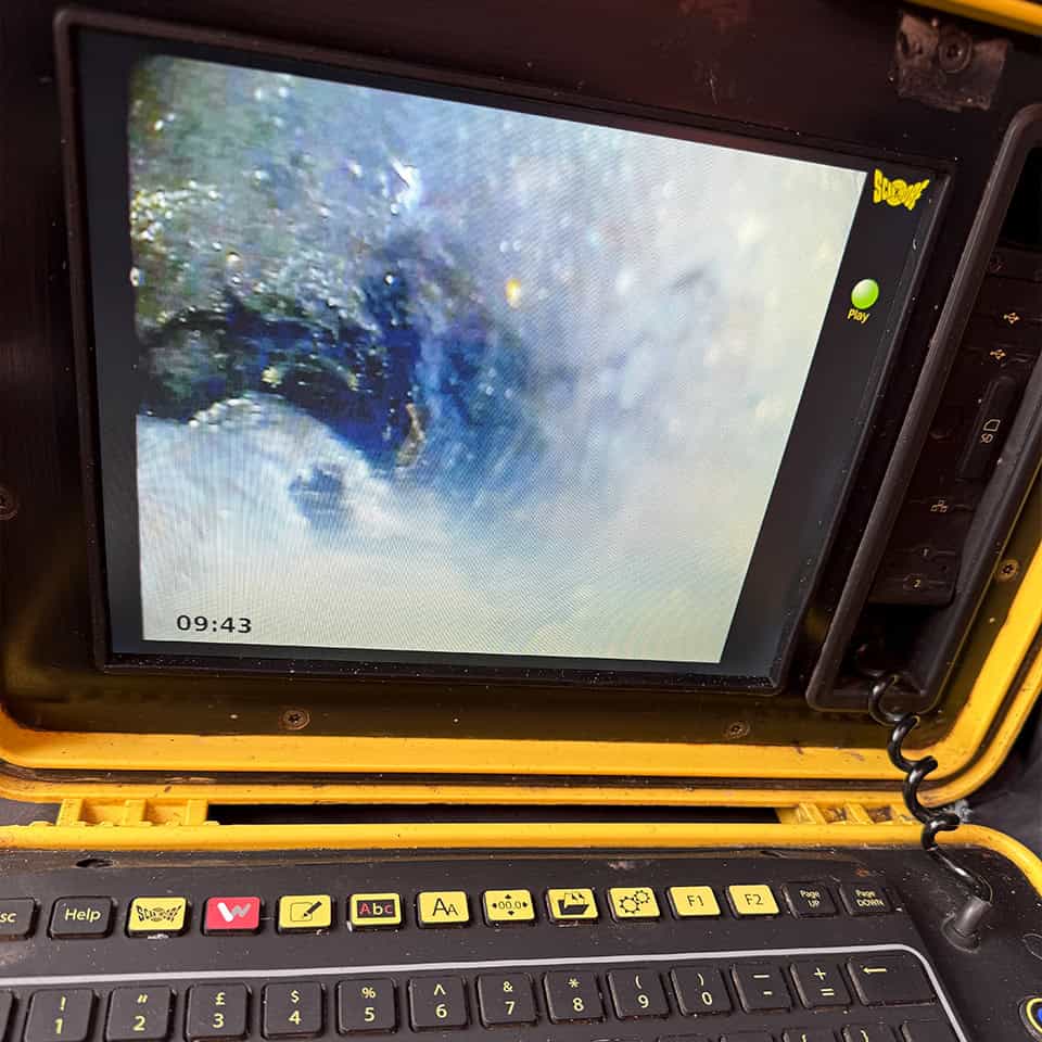Pipe inspection camera view of underground drainage system.